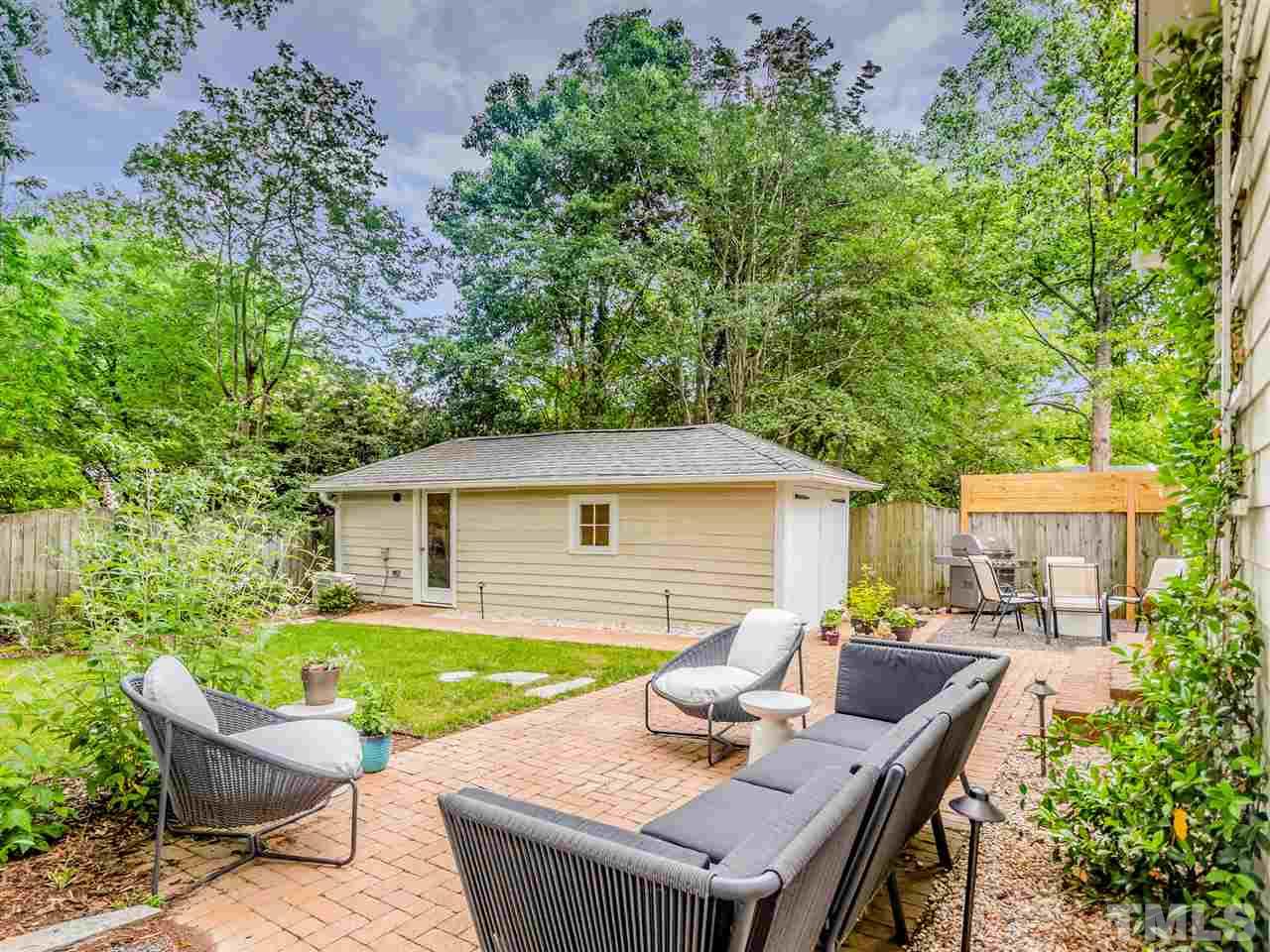 2215 The Circle Raleigh, NC 27608 - Photo 28 of 30 a view of backyard of house with seating space