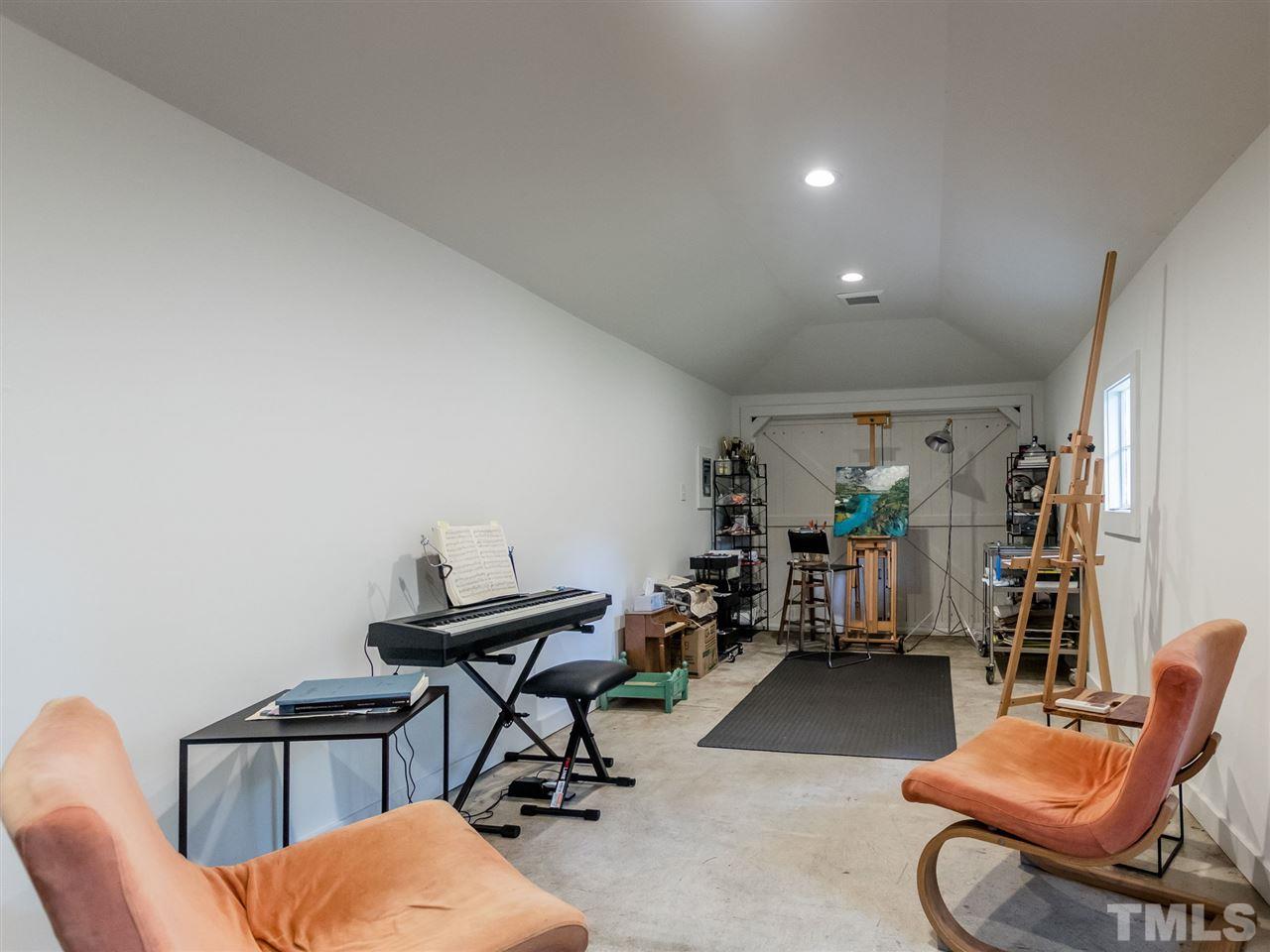 2215 The Circle Raleigh, NC 27608 - Photo 29 of 30 a view of a workspace with furniture and a workspace