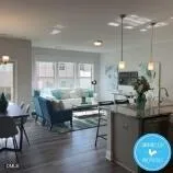 a kitchen with kitchen island granite countertop a table chairs sink and cabinets