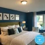 a bedroom with a large bed and a wooden floor