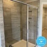 a bathroom with a glass shower door