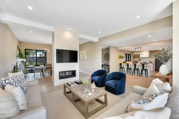 a living room with furniture a fireplace and a flat screen tv