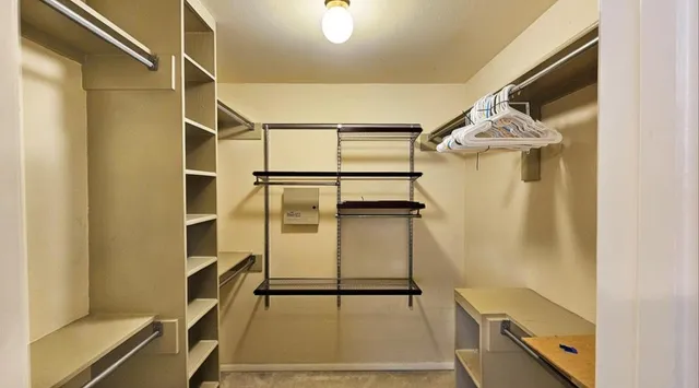 a view of backyard with barbeque grill and a wooden fence