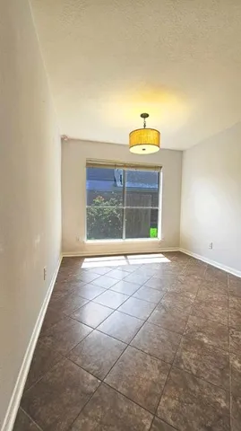 a view of a livingroom with a ceiling fan and window