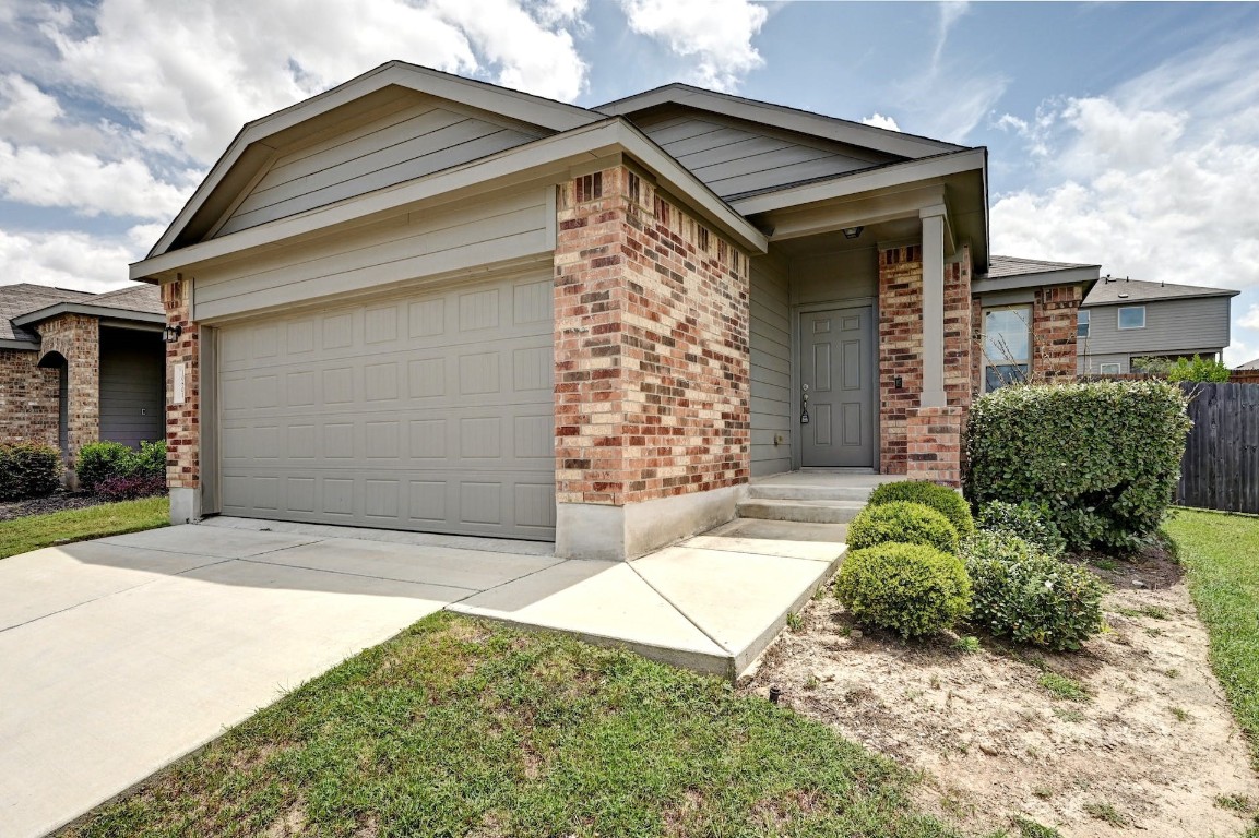 10801 Dimitrios Drive Austin, TX 78747 - Photo 1 of 1 a front view of a house with garden