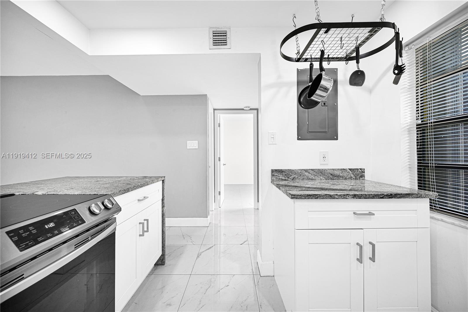 132 South Cypress Road, Unit 518 Pompano Beach, FL 33060 - Photo 12 of 60 a kitchen with a stove and a white refrigerator