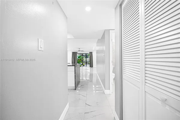 an empty room with kitchen view