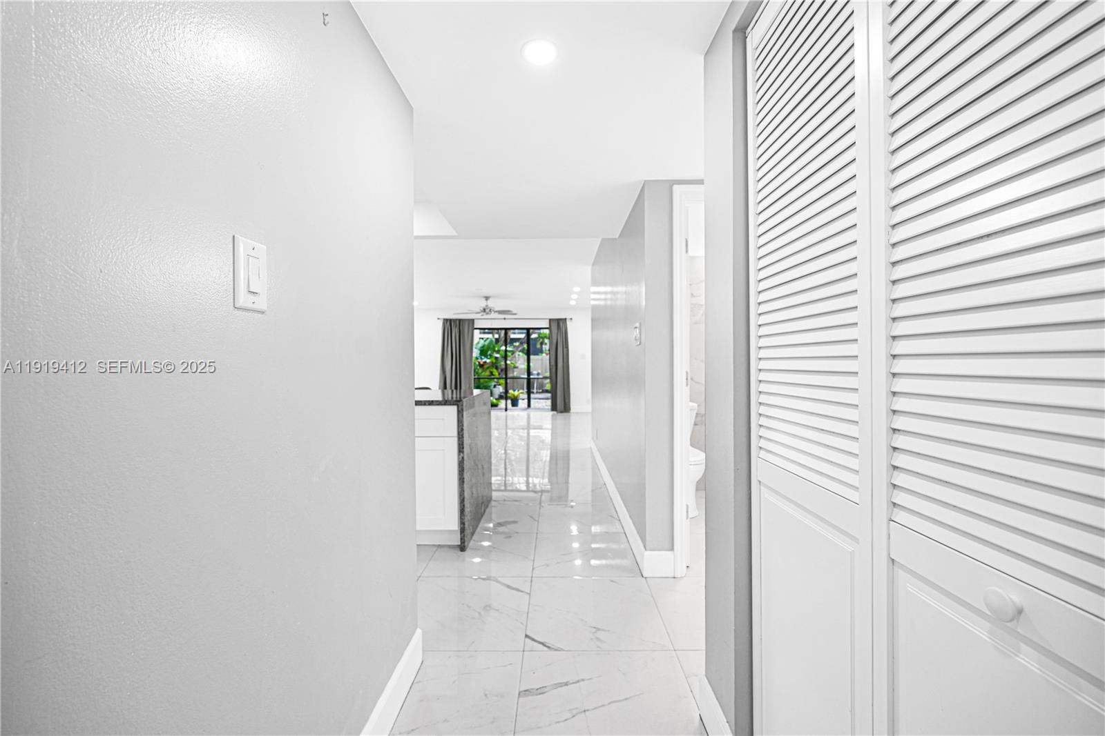 132 South Cypress Road, Unit 518 Pompano Beach, FL 33060 - Photo 14 of 60 a view of a hallway with wooden shelves