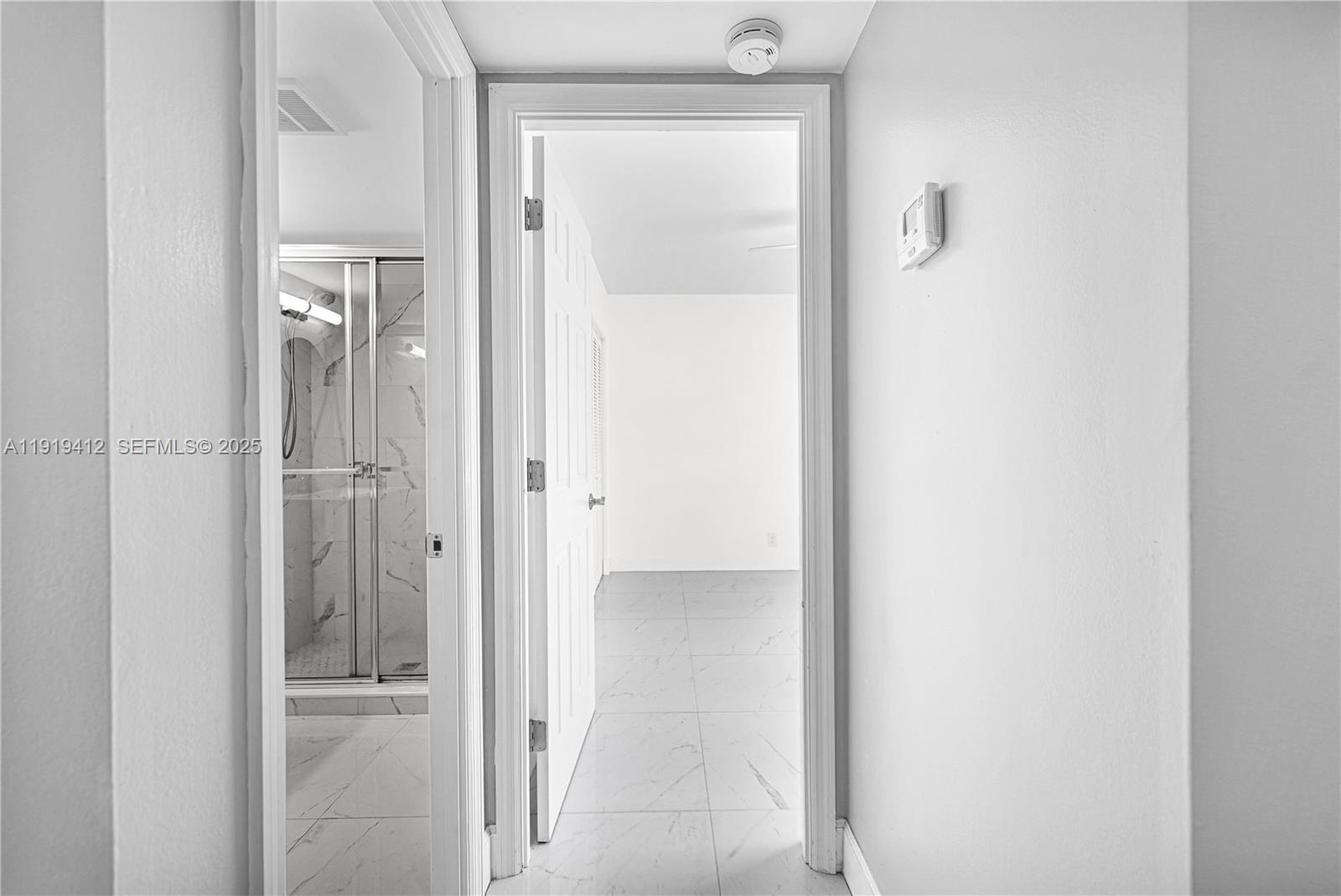 132 South Cypress Road, Unit 518 Pompano Beach, FL 33060 - Photo 18 of 60 a view of a bathroom from a hallway