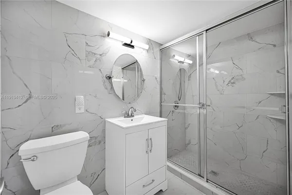 an empty room with a window and a ceiling fan