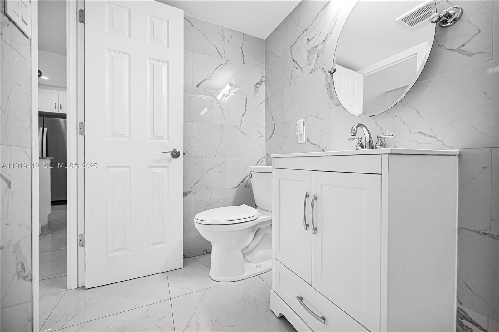 132 South Cypress Road, Unit 518 Pompano Beach, FL 33060 - Photo 20 of 60 a bathroom with a toilet sink and mirror