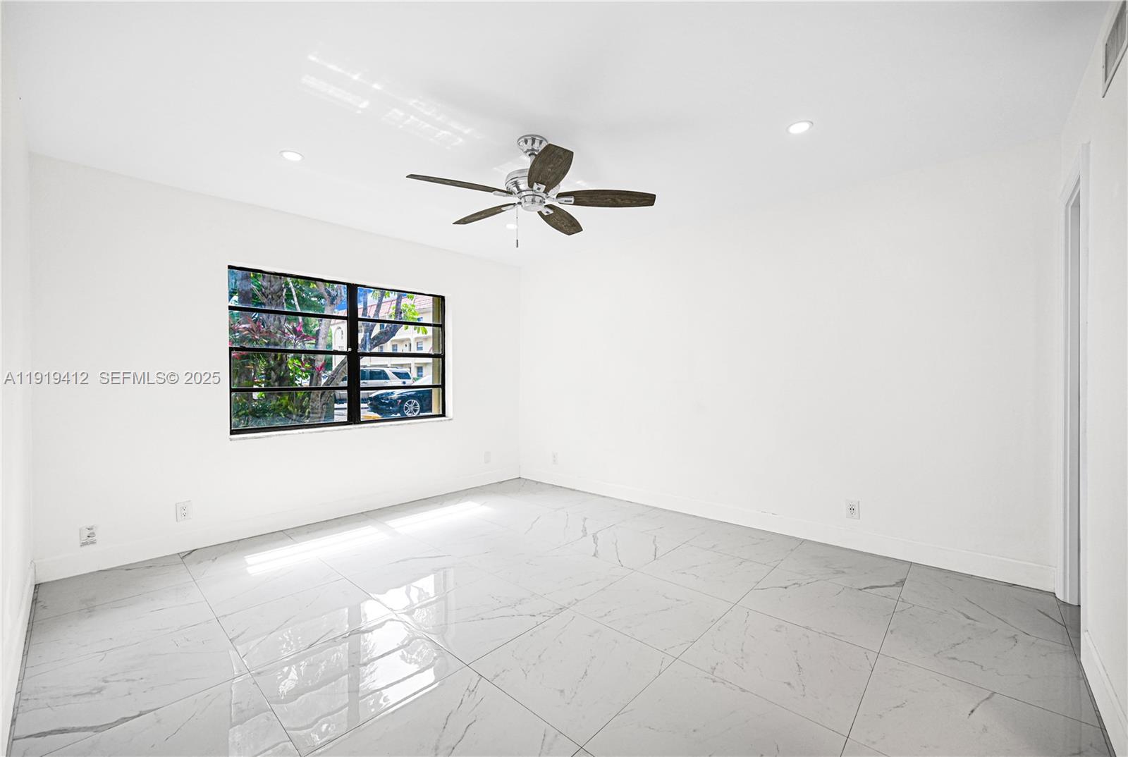 132 South Cypress Road, Unit 518 Pompano Beach, FL 33060 - Photo 21 of 60 an empty room with windows and ceiling fan