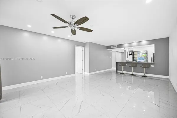 a kitchen with granite countertop a sink a stove and refrigerator