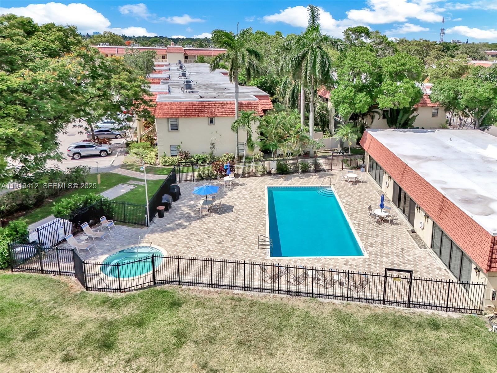 132 South Cypress Road, Unit 518 Pompano Beach, FL 33060 - Photo 53 of 60 a view of swimming pool with outdoor seating and plants