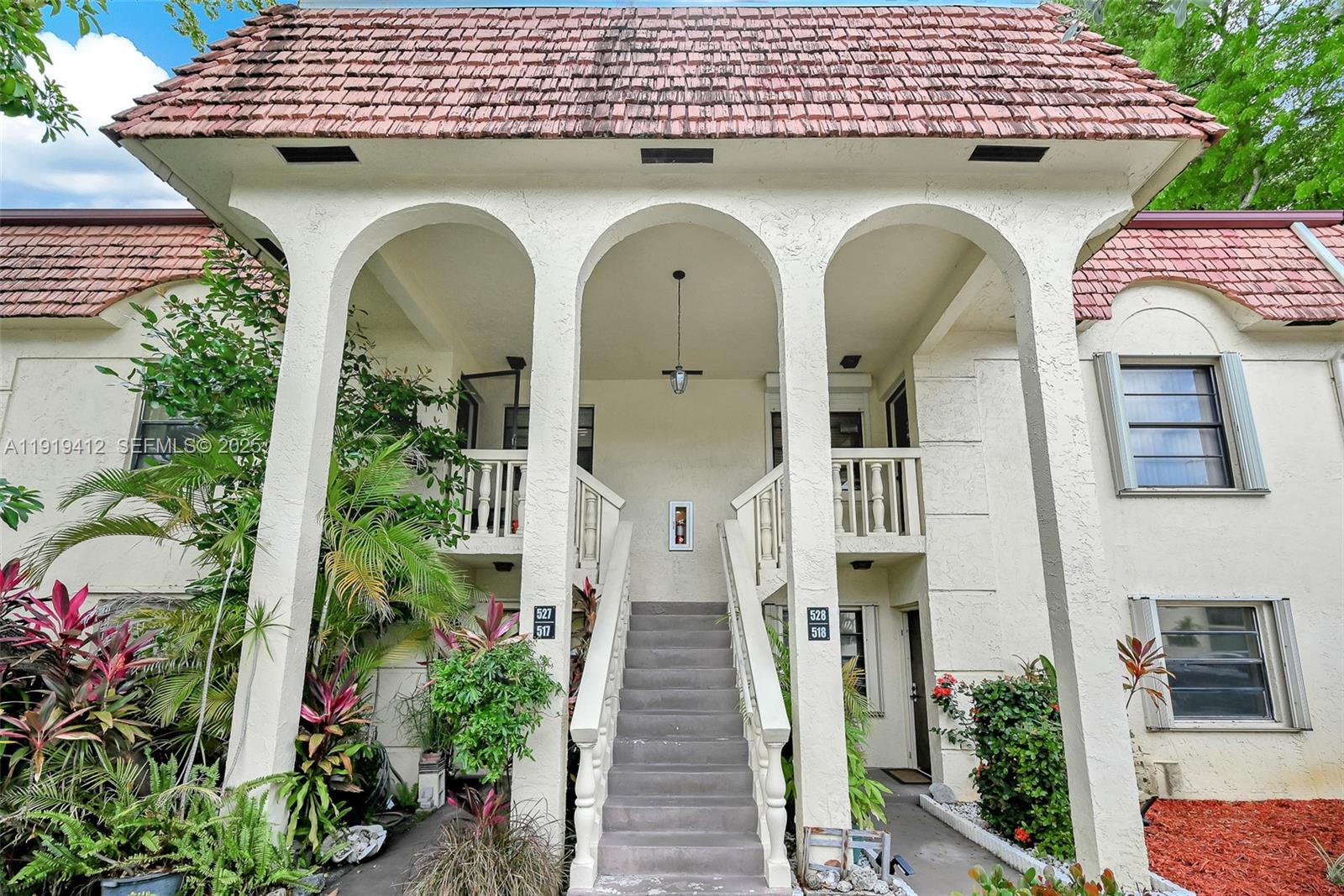 132 South Cypress Road, Unit 518 Pompano Beach, FL 33060 - Photo 58 of 60 a front view of a house with a garden