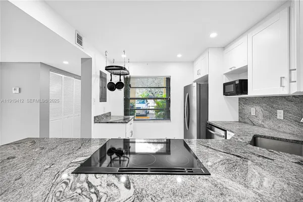 a kitchen with a refrigerator sink and microwave