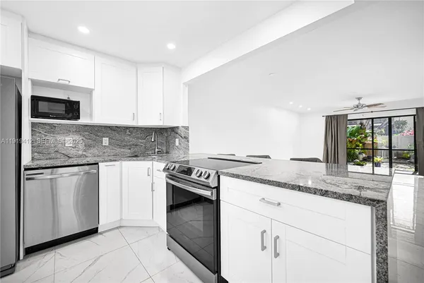 a kitchen with a stove top oven sink and cabinets