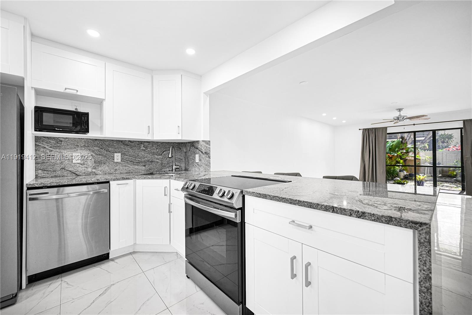 132 South Cypress Road, Unit 518 Pompano Beach, FL 33060 - Photo 9 of 60 a kitchen with granite countertop cabinets stainless steel appliances and a sink