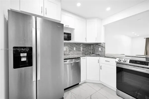 a kitchen with a stove and a white refrigerator