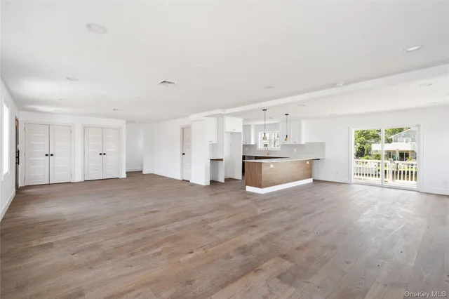 a view of a livingroom with an empty space and a window
