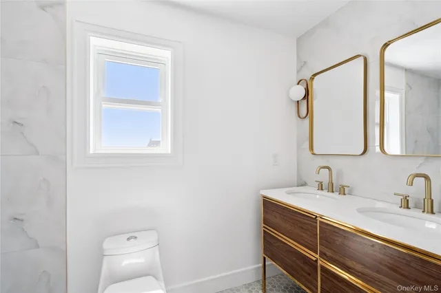 a bathroom with a sink vanity and a mirror