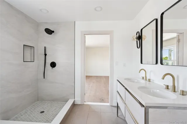 a bathroom with a shower sink and mirror