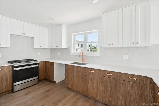 a kitchen with granite countertop white cabinets and stainless steel appliances