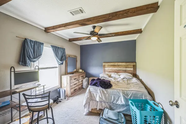 a bedroom with furniture and a window