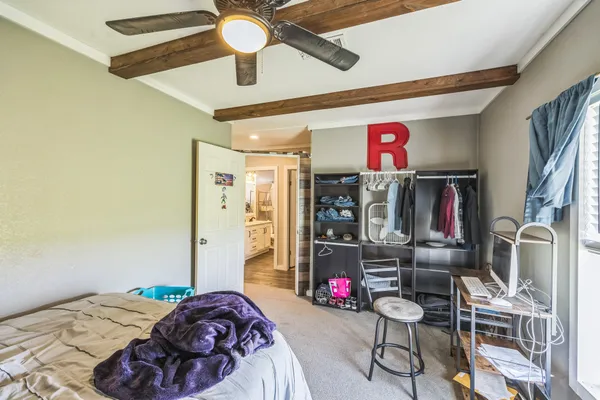 a bedroom with a bed a desk and chair