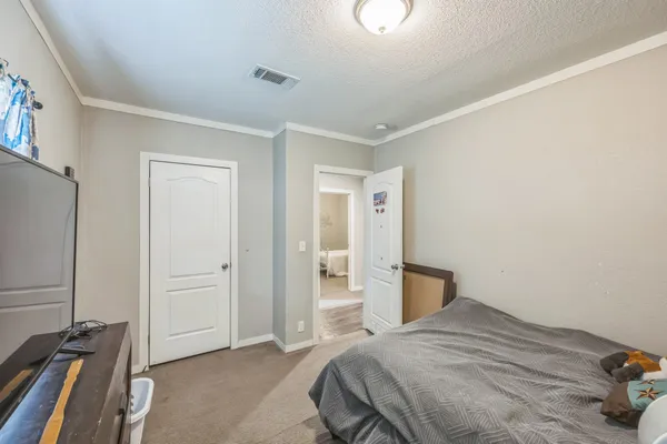a bedroom with a bed and a desk