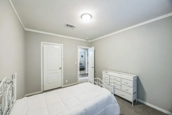 a bedroom with a bed and a view of bedroom