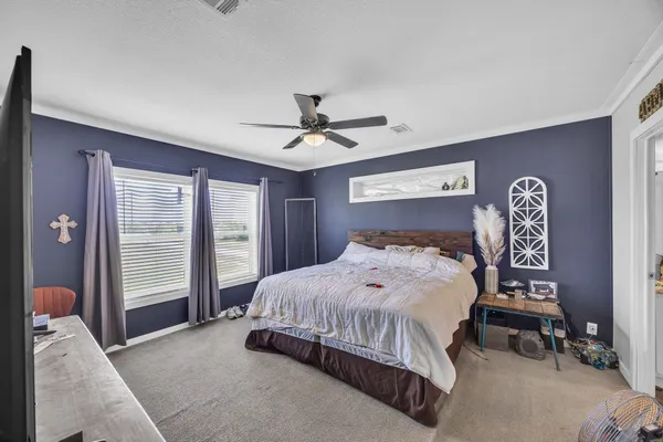 a bedroom with a bed and a chandelier