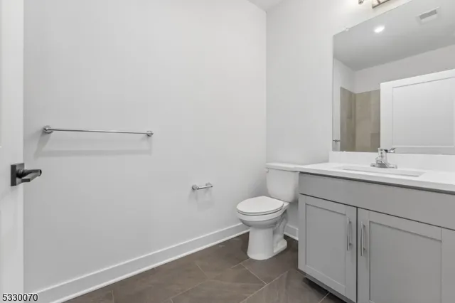 a bathroom with a sink toilet and vanity
