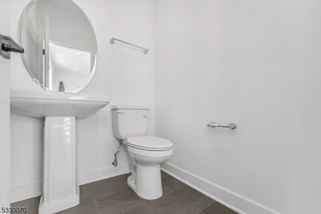 a bathroom with a toilet and a mirror