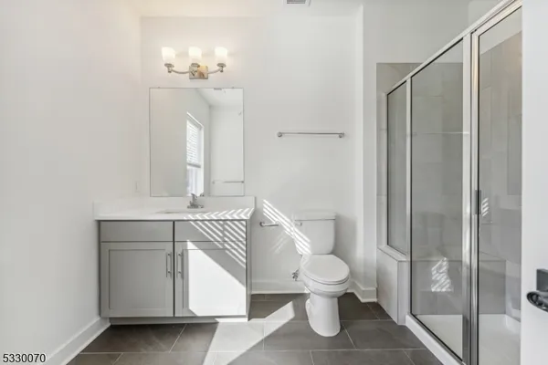 a bathroom with a toilet a sink and shower