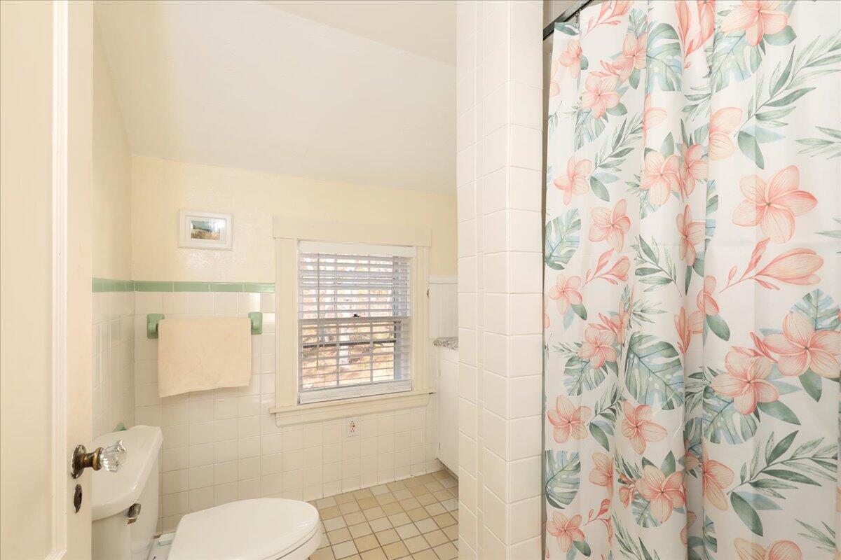 45 Cottontail Road Wellfleet, MA 02667 - Photo 23 of 44 a bathroom with a toilet and a shower curtain