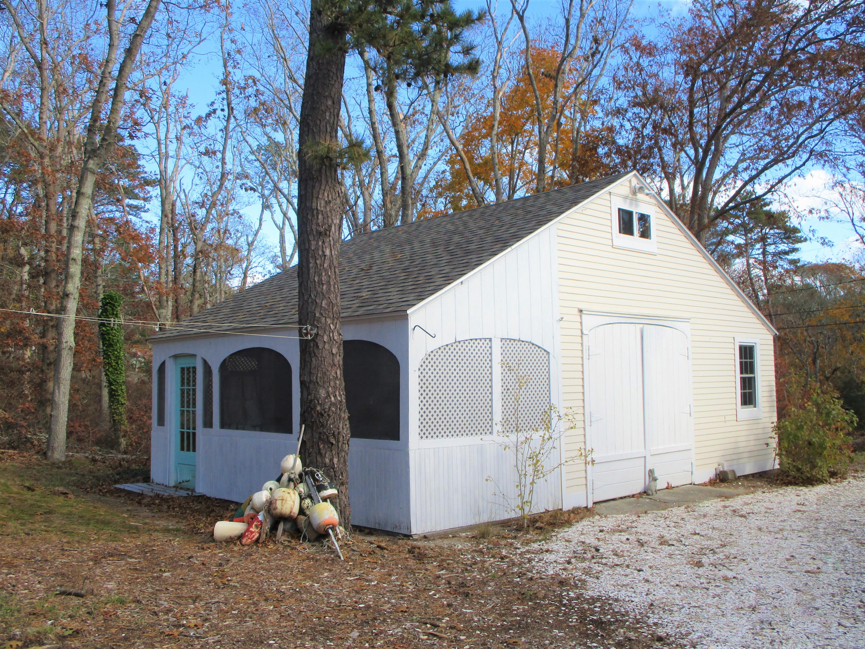 45 Cottontail Road Wellfleet, MA 02667 - Photo 30 of 44 a view of a white house with a large tree