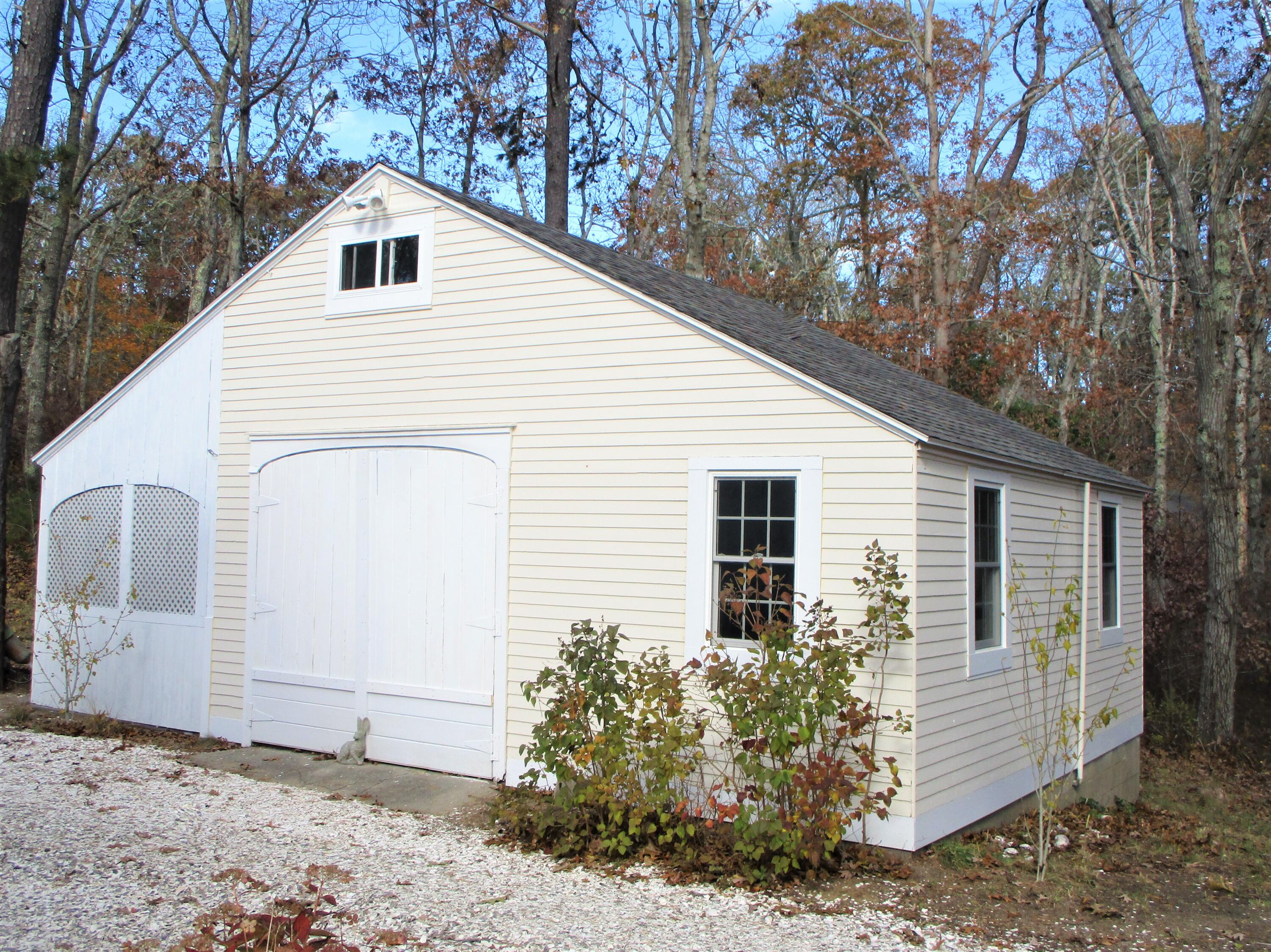 45 Cottontail Road Wellfleet, MA 02667 - Photo 32 of 44 a view of a white house with a yard and large tree