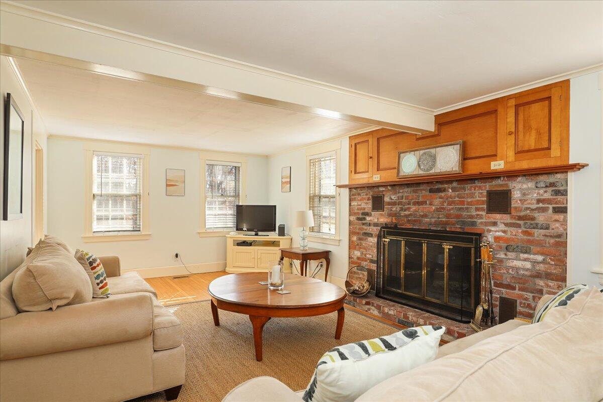 45 Cottontail Road Wellfleet, MA 02667 - Photo 5 of 44 a living room with furniture a fireplace and a flat screen tv
