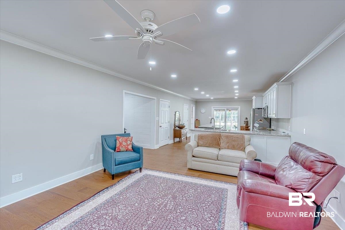 14160 Moffett Road Wilmer, AL 36587 - Photo 12 of 75 Living area featuring light wood-style flooring and crown molding