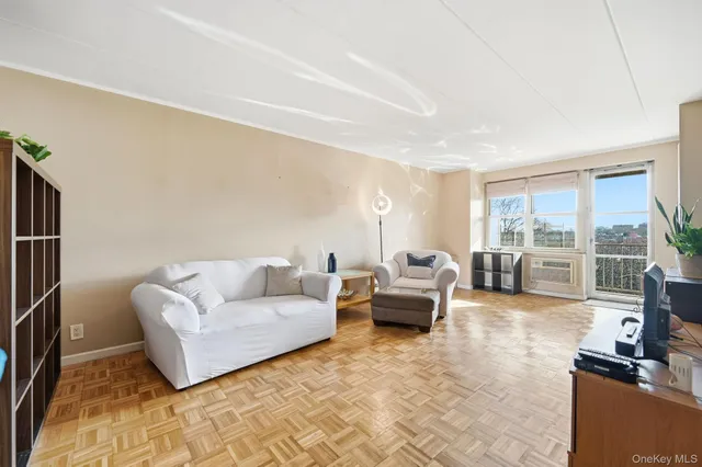 a living room with furniture large window and flat screen tv