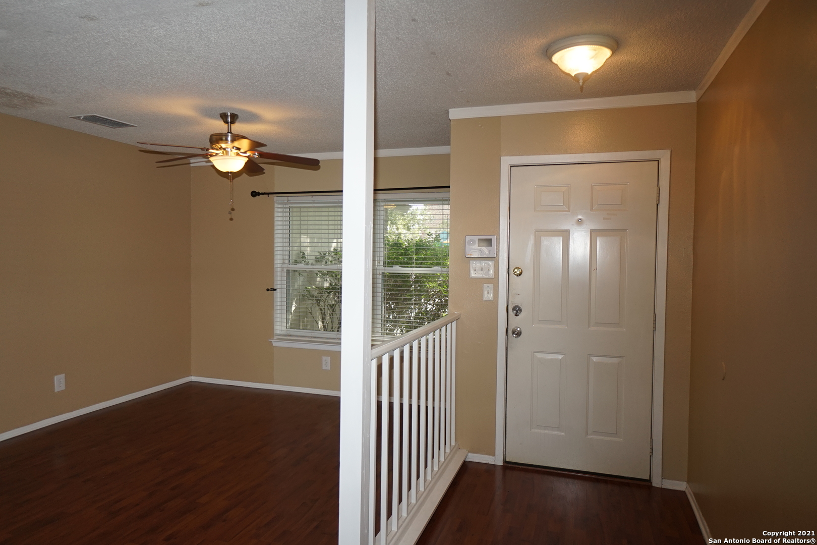 811 Meadow Scape Converse, TX 78109 - Photo 2 of 19 wooden floor in an empty room with a window