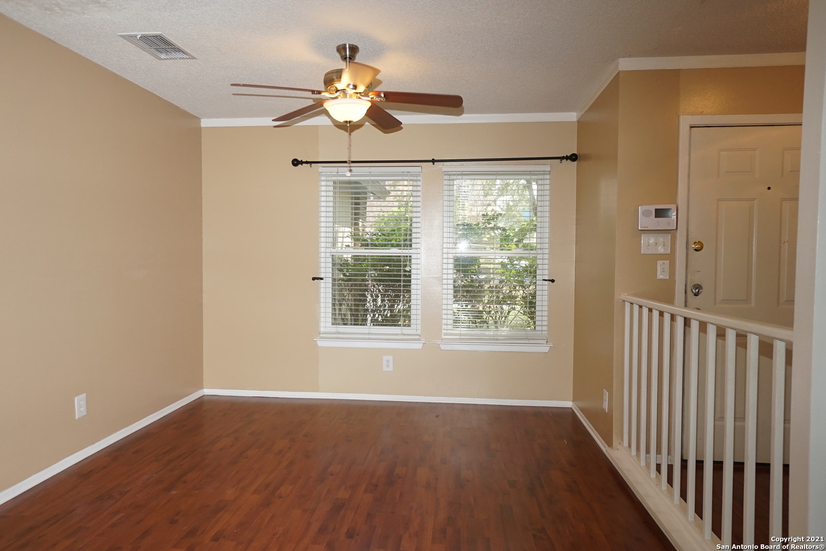 811 Meadow Scape Converse, TX 78109 - Photo 3 of 19 a view of an empty room with wooden floor and a window
