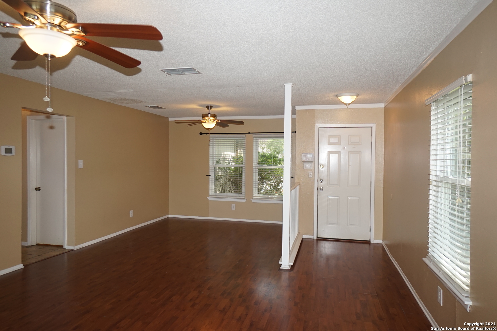 811 Meadow Scape Converse, TX 78109 - Photo 4 of 19 a view of an empty room with wooden floor and a window