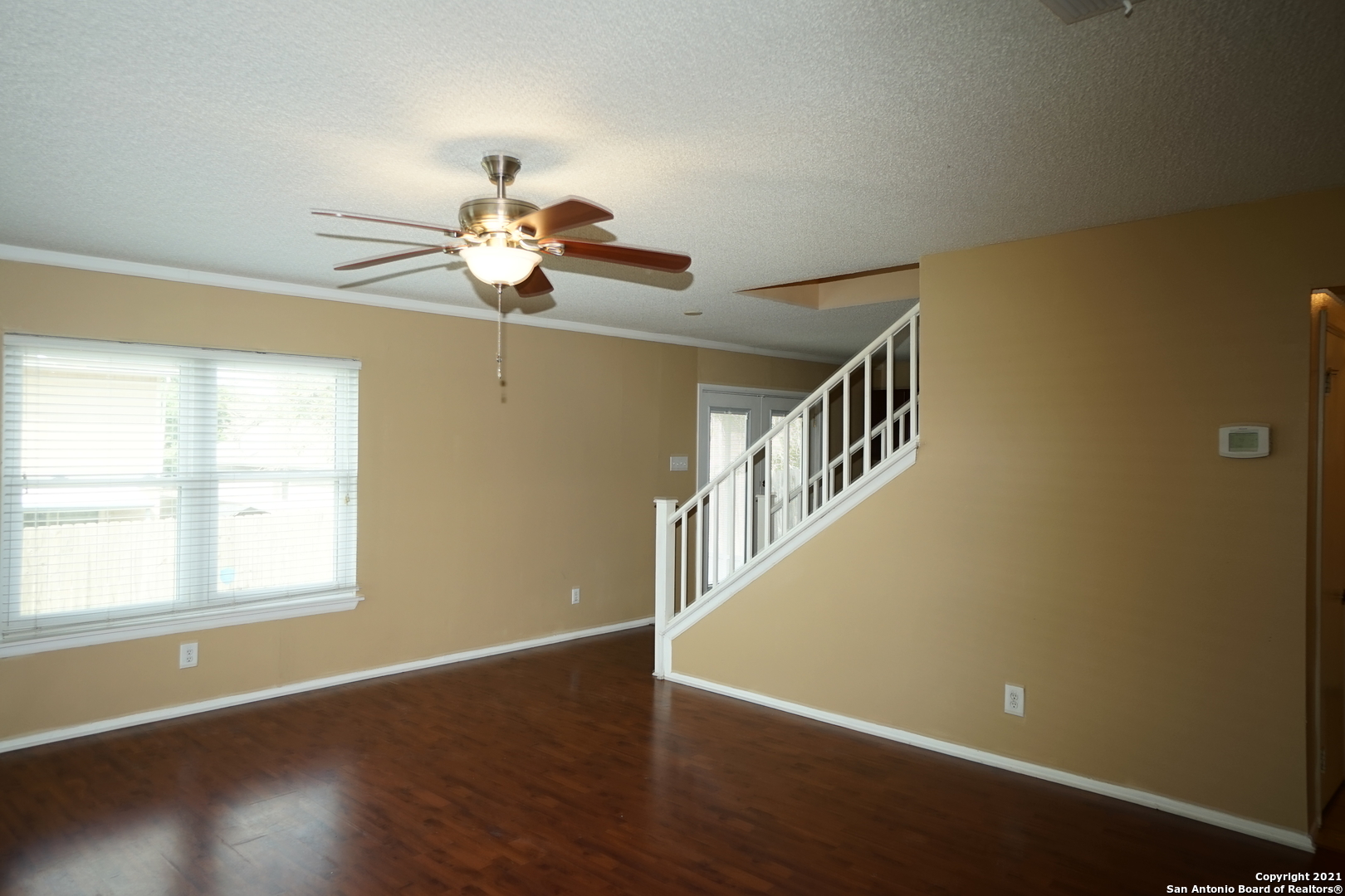 811 Meadow Scape Converse, TX 78109 - Photo 6 of 19 a view of an empty room with wooden floor and a window