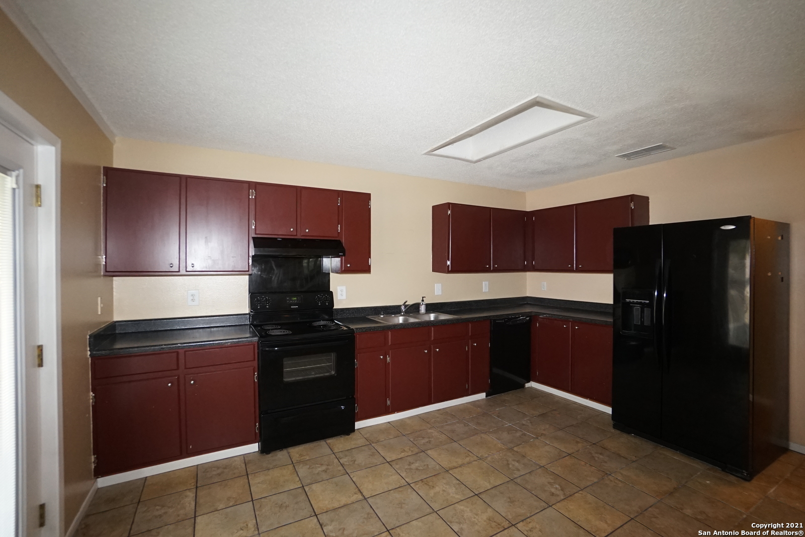 811 Meadow Scape Converse, TX 78109 - Photo 7 of 19 a kitchen with stainless steel appliances granite countertop a refrigerator and a stove