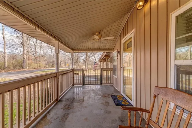 a view of a porch with wooden floor and furniture