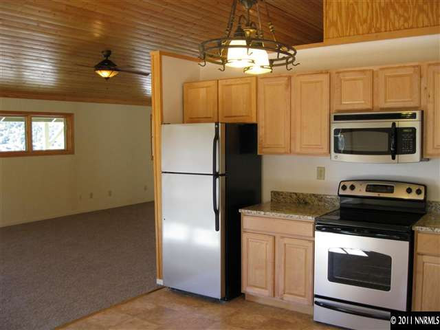 2830 Goldfield Road Reno, NV 89521 - Photo 3 of 13 a kitchen with a refrigerator stove and microwave