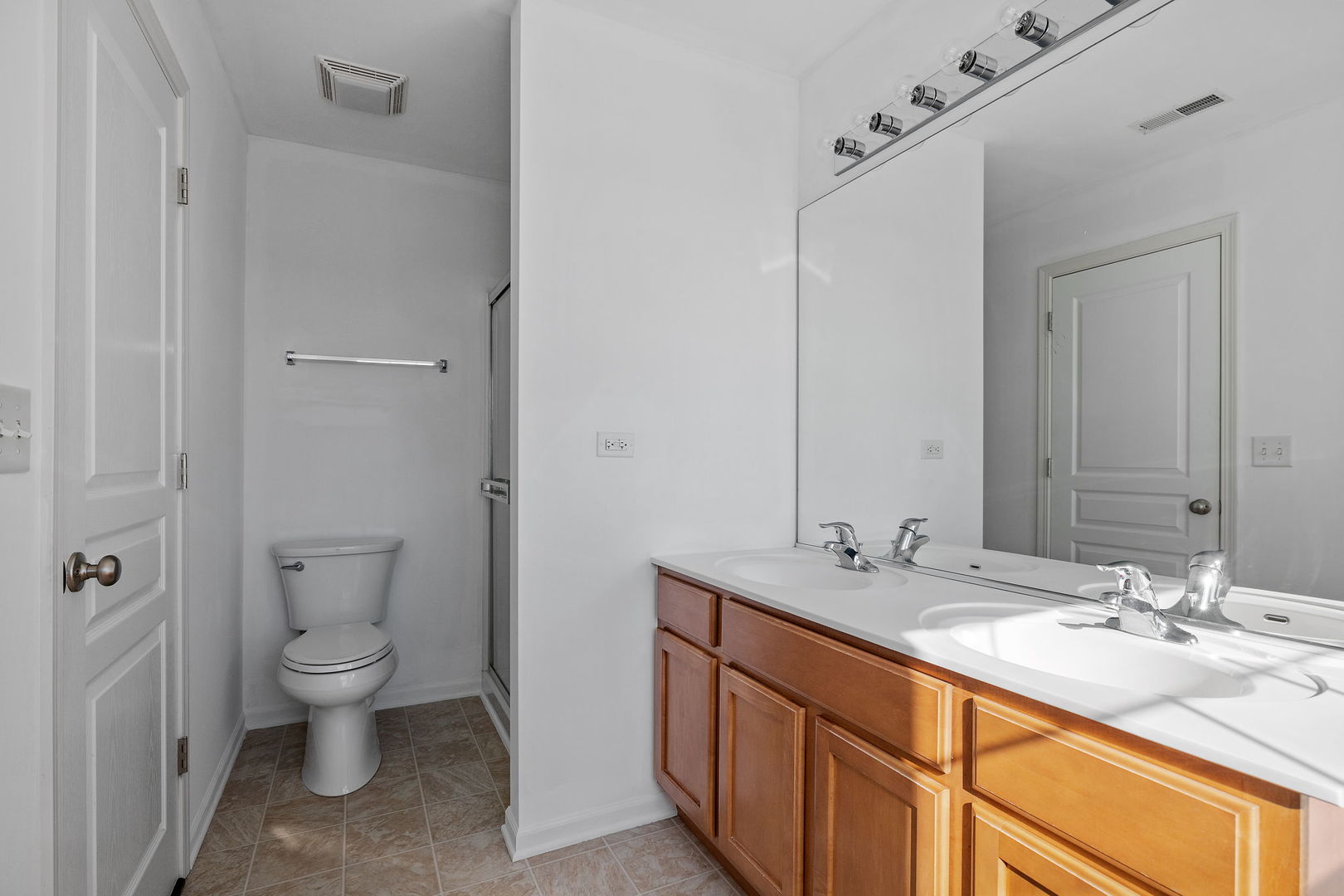 15341 Pinewood Road, Unit 15341 Lockport, IL 60441 - Photo 14 of 21 a bathroom with a granite countertop sink a toilet and a large mirror