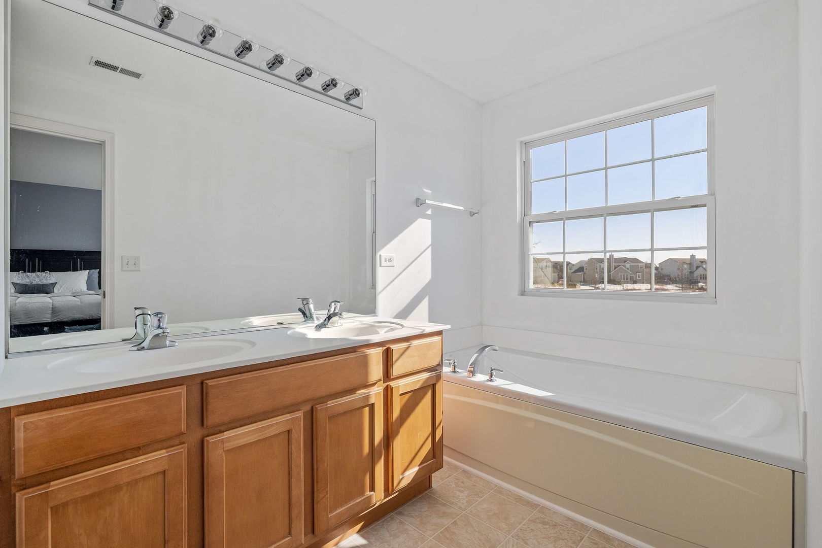 15341 Pinewood Road, Unit 15341 Lockport, IL 60441 - Photo 15 of 21 a bathroom with a sink double vanity granite tub and a mirror